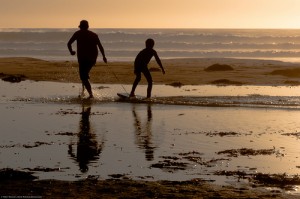 Father and son playing and bonding on Bogey-Board on Morro Stran
