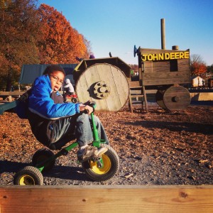 Isaiah on a pedal tractor at Butler's Orchard