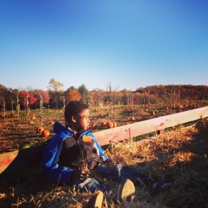 Isaiah on a hayride at Butler's Orchard