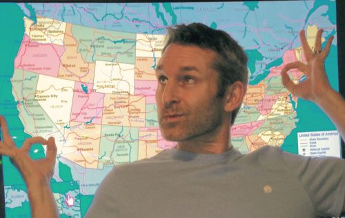Adam with map of SD vs. NY