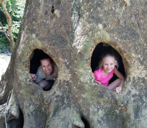 A Father's Perspective. Father and daughter in a hollowed out tree.