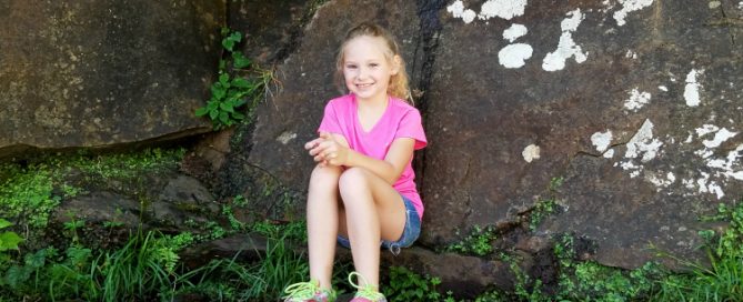 A Father's Perspective. Image of daughter posing on rocks.