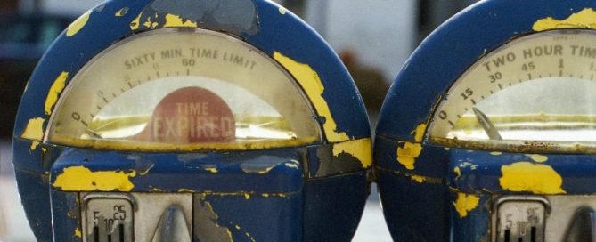 Avoiding Parking Tickets, Image of two beat up parking meters
