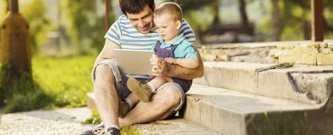 Father and son using an iPad