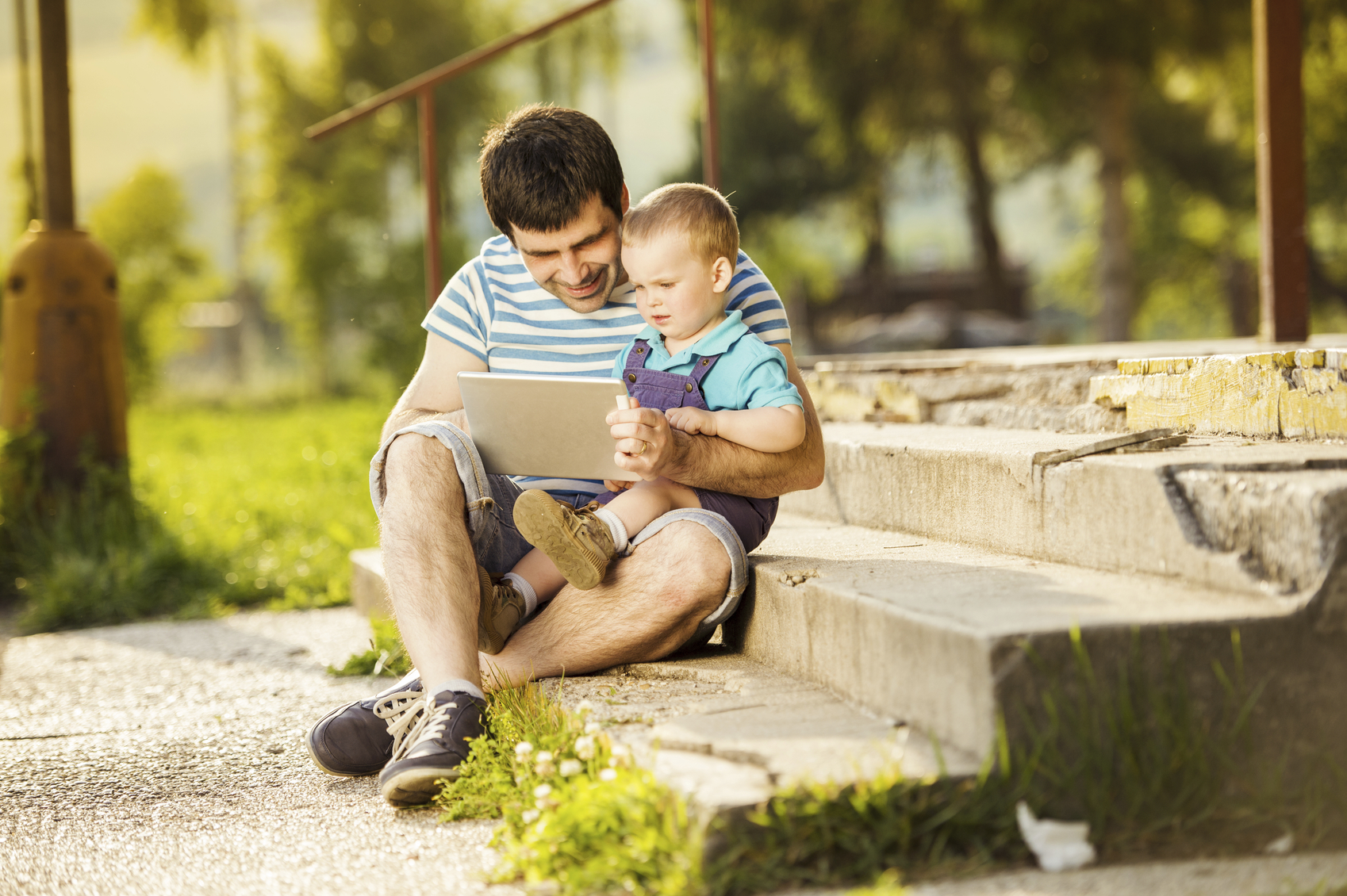 Father and son using an iPad