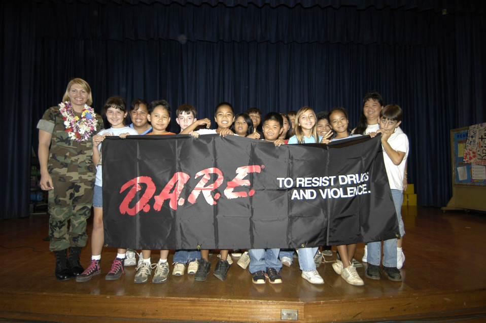 050531-N-3207B-046 Pearl Harbor, Hawaii (May 31, 2005) Ð Master-at-Arms 1st Class Stacey Carfley stands with her recent class of Drug Abuse Resistance Education (D.A.R.E.) program graduates from a <a href=