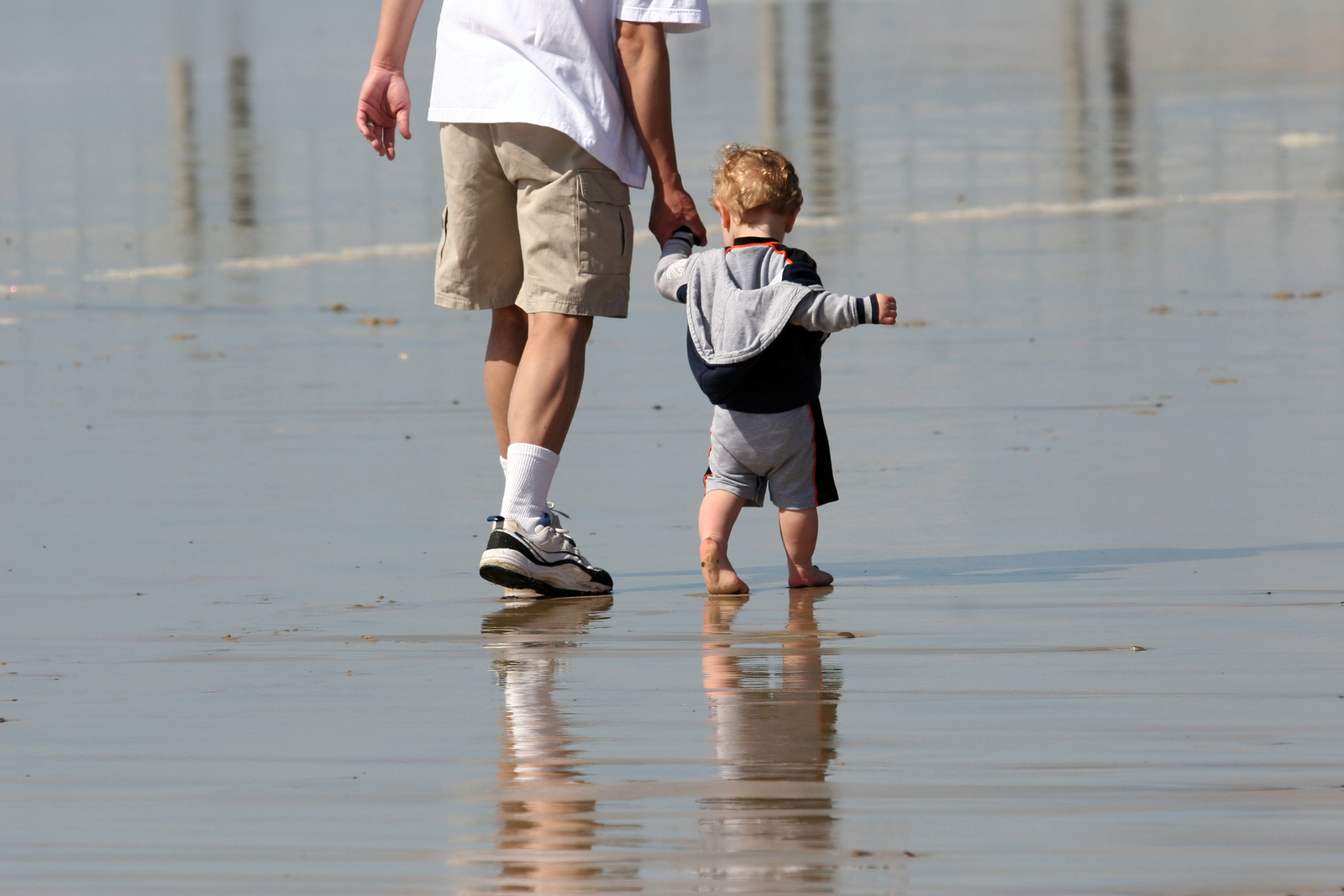 father and son walking on the beach